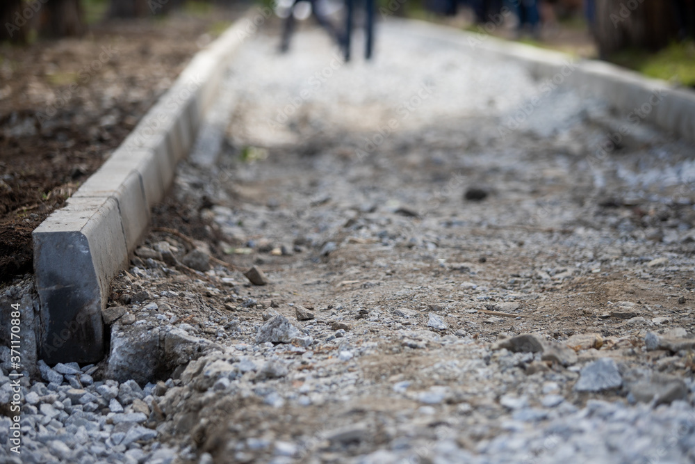Naklejka premium Reconstruction of the sidewalk and replacement of old curbs. Construction zone