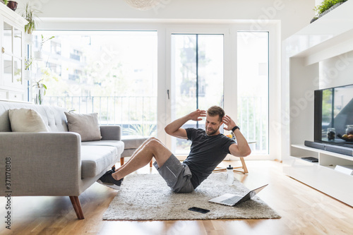 Handsome man working out at home photo