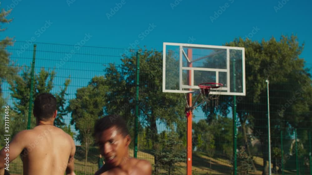 Muscular build african basketball defender jumping to block shot
