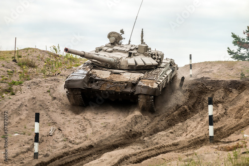 battle tank performs exercises for driving military equipment on a tank range