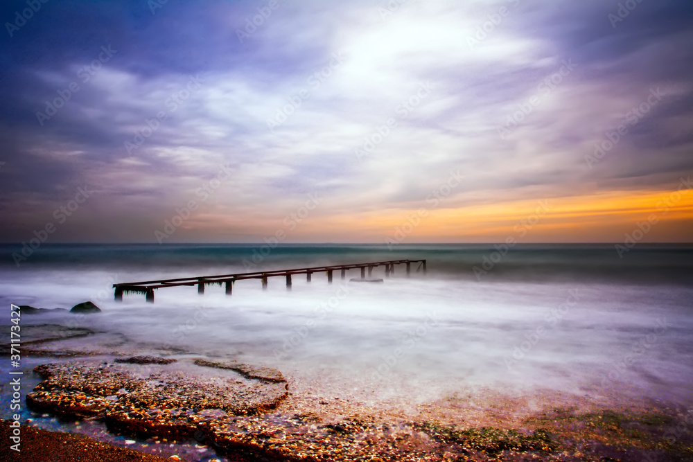 Obraz premium Old Worn Pier Columns, Logs of remains of the old, wooden pier, in the sea