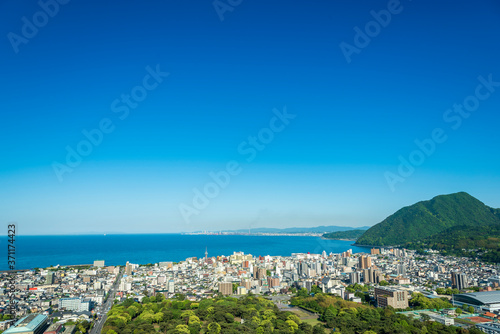 Cityscape view of Beppu city and Beppu bay with blue sky background, Oita, Kyushu, Japan