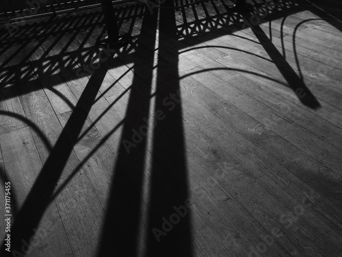 shadow of fence on wood floor black and white style