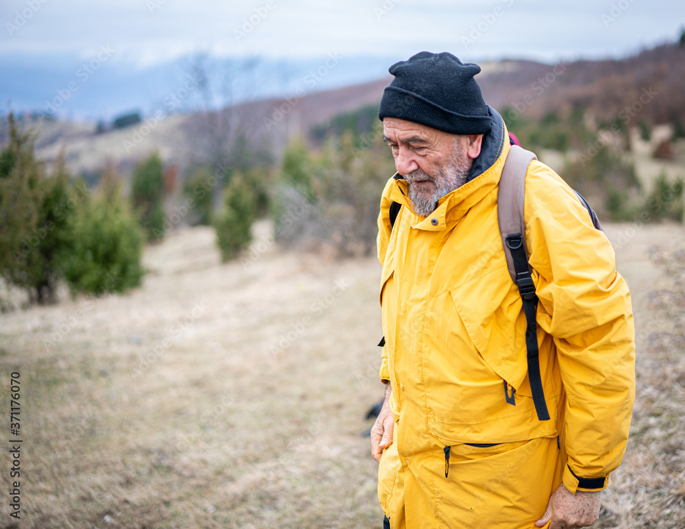 Senior man walking in nature Senior man walking in nature