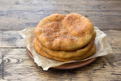 Homemade Navajo fried bread or sweet Elephant Ears with brown sugar and cinnamon  on wooden table photo