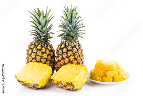 Sliced pineapple on a white plate, it is a sweet and juicy fruit.