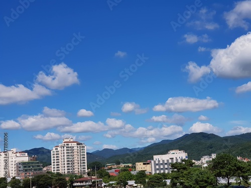 blue, sky, white building, green trees