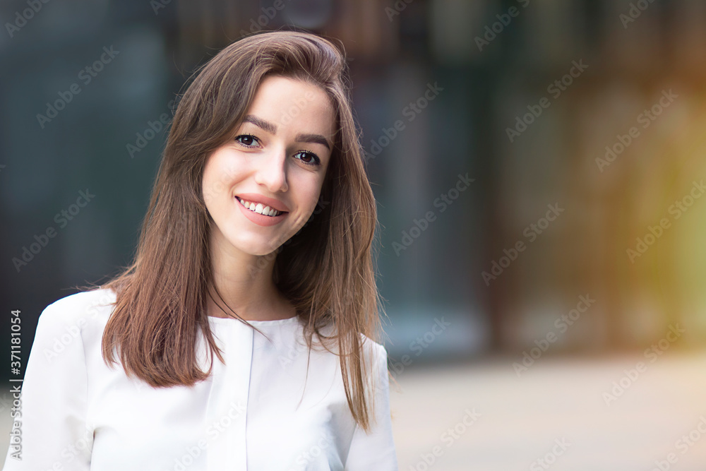 Close up beauty portrait of young professional woman in business suit showing toothy smile at the camera Close up beauty portrait of young professional woman in business suit showing toothy smile at the camera