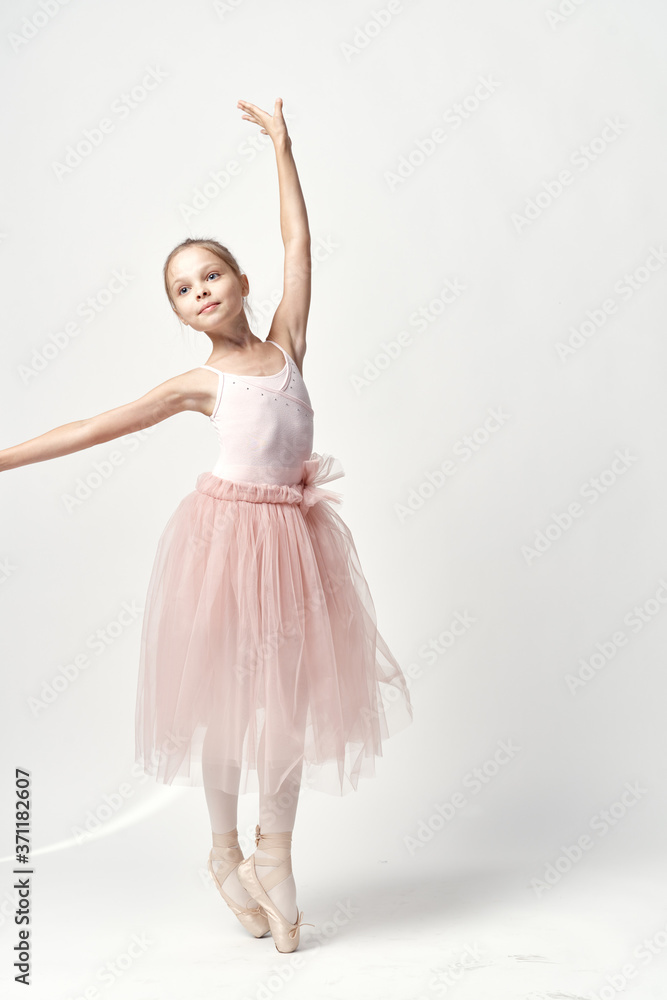 Girl ballerina in pink dance costume ballet dance pointe shoes tutu light background model Girl ballerina in pink dance costume ballet dance pointe shoes tutu light background model