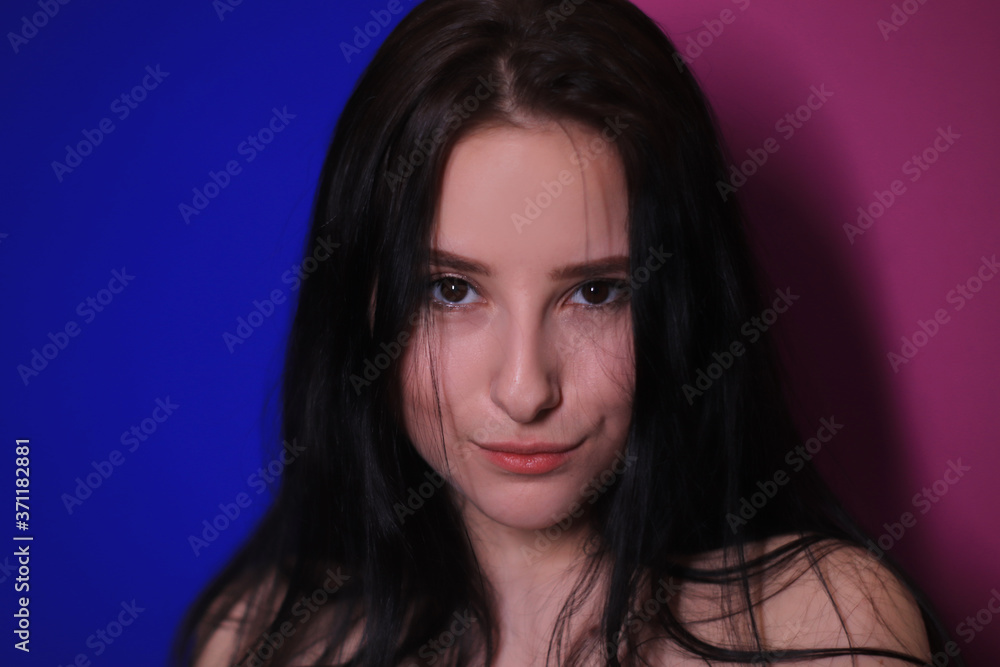 emotional portrait of a brunette girl on a pink-blue background emotional portrait of a brunette girl on a pink-blue background