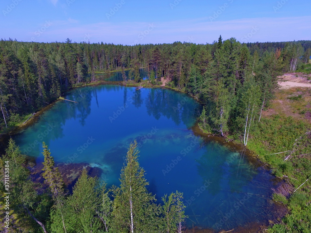 Blue lakes in a coniferous forest. Parashikimi lake, Komi Republic, Russia.