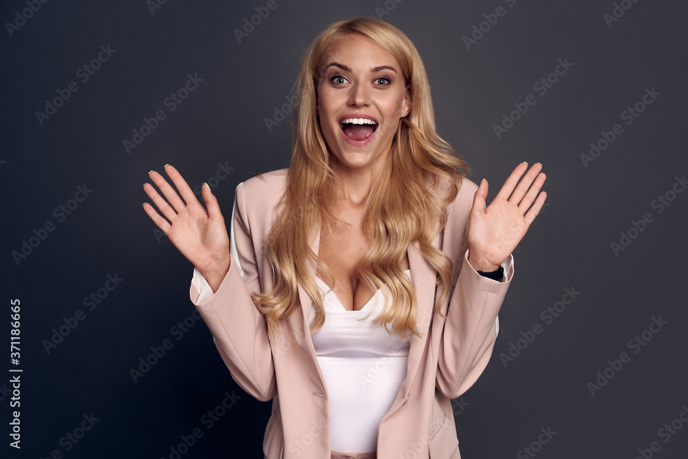 Photo of beautiful funny lady hold hands fists raised yelling loud wear pink suit isolated on grey color background Photo of beautiful funny lady hold hands fists raised yelling loud wear pink suit isolated on grey color background