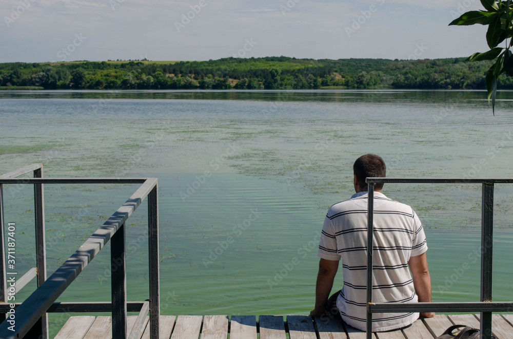 man sitting on a dock