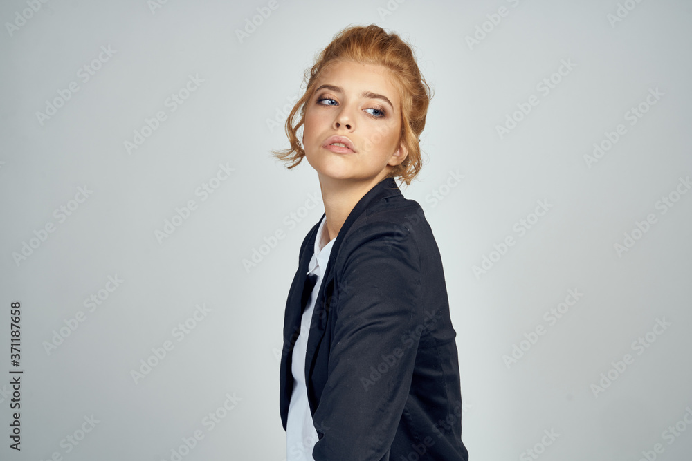Portrait of a female businesswoman in a white shirt and a blonde model in a jacket on a light background Portrait of a female businesswoman in a white shirt and a blonde model in a jacket on a light background