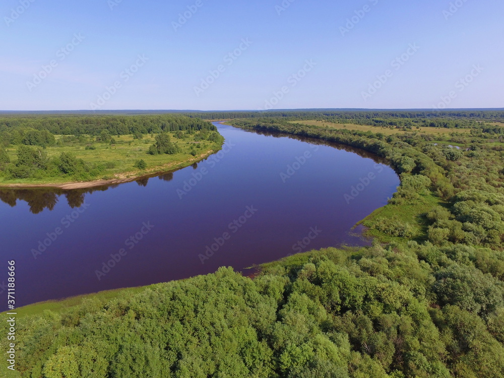 Bend of the Vychegda river against the blue sky, Komi Republic, Russia.