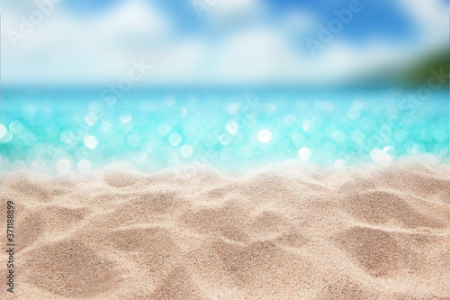 Summer paradise sandy beach with blur palms and bokeh light in the sea Summer concept