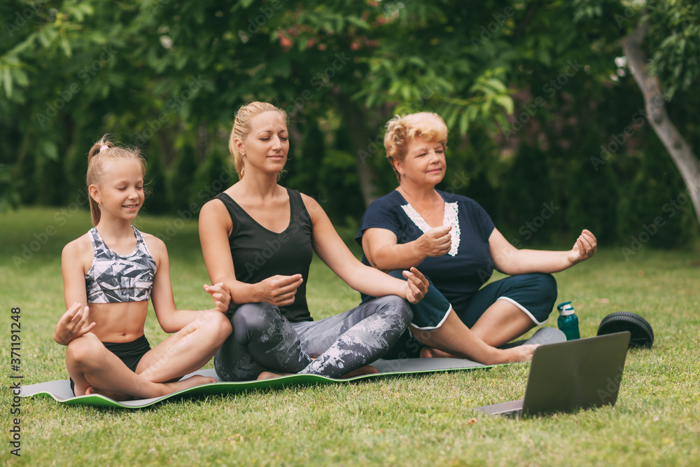 Grandmother, mom and child meditate together in nature. Go in for sports. Healthy lifestyle Grandmother, mom and child meditate together in nature. Go in for sports. Healthy lifestyle