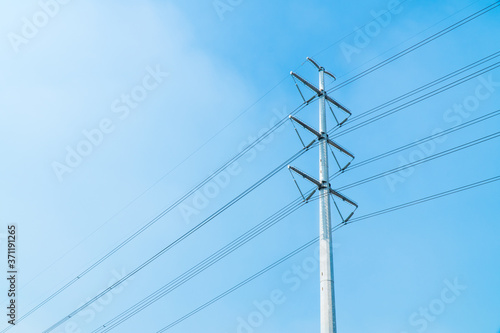 Low angle view of new and clean single electricity pole with beautiful bright blue sky.