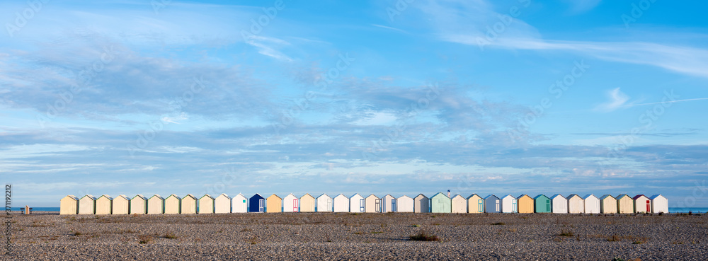beach huts in cayeux s mer in french normandy under blue sky