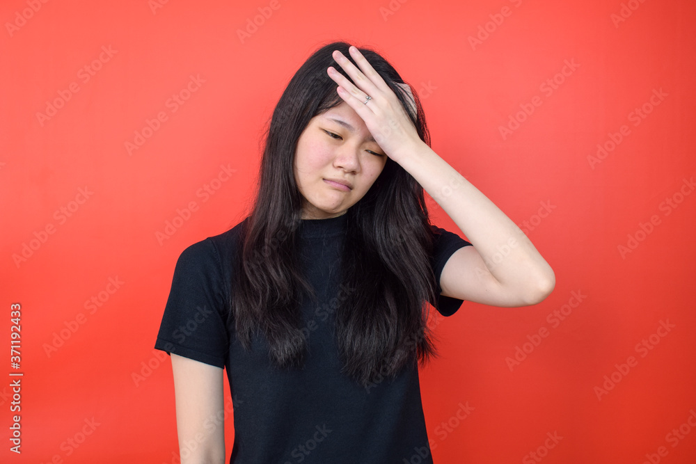 Portrait of Young beautiful asian woman using black T-shirt with red isolated background Portrait of Young beautiful asian woman using black T-shirt with red isolated background