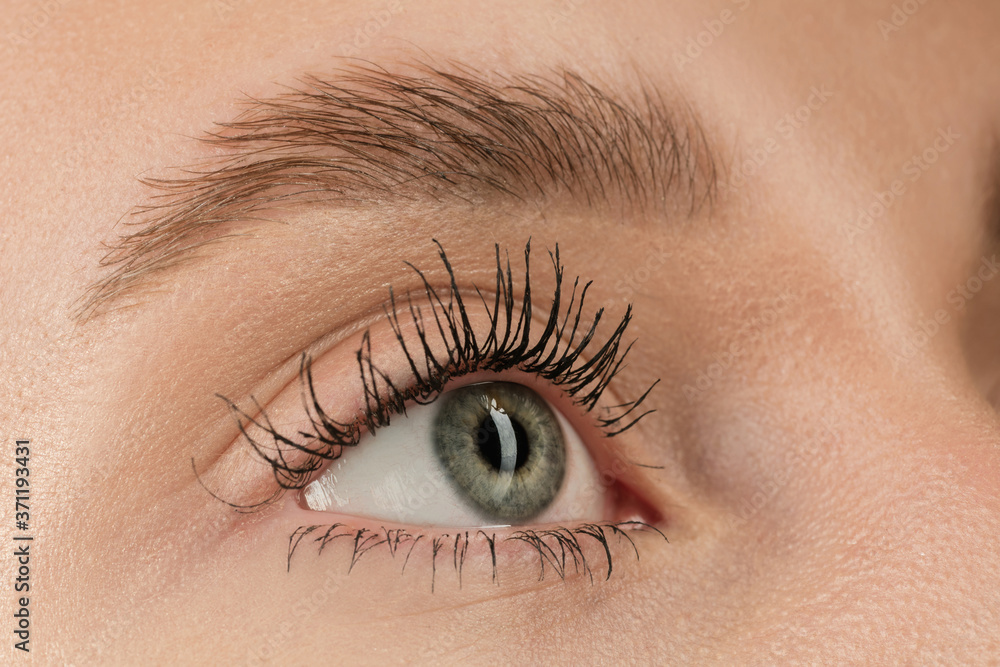 Obraz premium Hopeful. Close up of face of beautiful caucasian young woman, focus on eyes. Human emotions, facial expression, cosmetology, body and skin care concept. Well kept cheeks, narutal make up. Wellbeing.