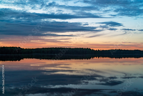 Colorful sunset on a forest lake in summer. © amarinchenko106