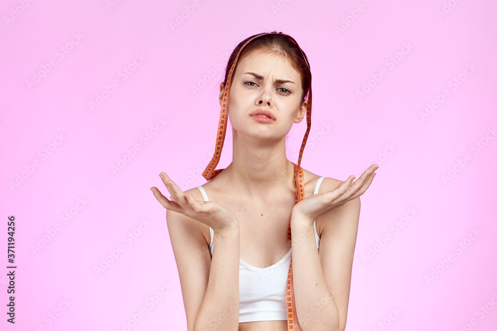 woman with measuring tape in hands white tank top body care fitness lifestyle pink background woman with measuring tape in hands white tank top body care fitness lifestyle pink background