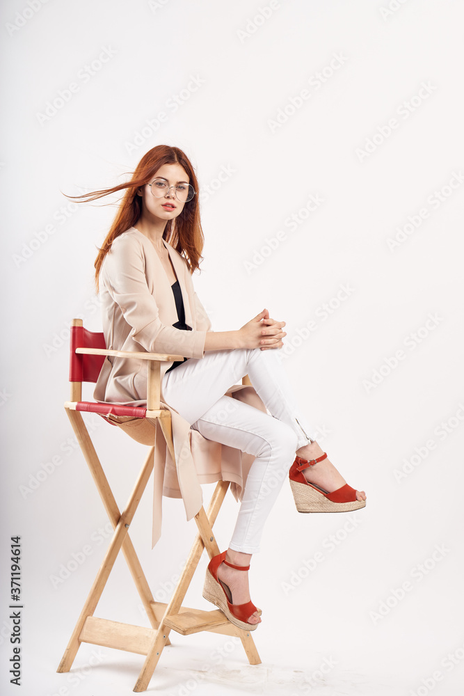 woman on a red chair in a bright room and sandals jacket woman on a red chair in a bright room and sandals jacket