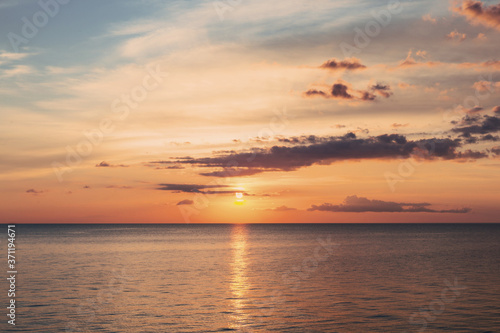 Beautiful orange sunset of the sea beach with rays of deep blue sky and sun © Anna