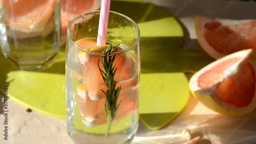 girl makes and drinks Diet. Healthy Eating Woman Drinking Fresh Raw rosemary grapefruit water