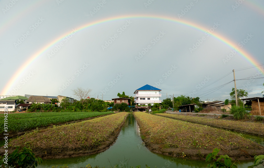 rainbow over the river and village