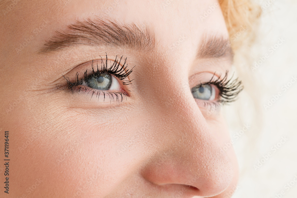 Obraz premium Laughting. Close up of face of beautiful caucasian young woman, focus on eyes. Human emotions, facial expression, cosmetology, body and skin care concept. Well kept cheeks, narutal make up. Wellbeing.
