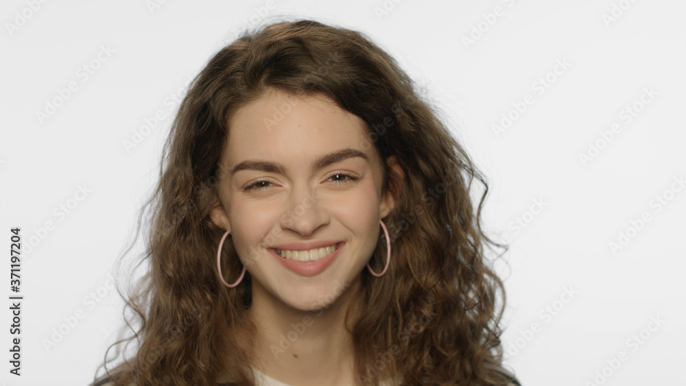 Curly hair woman smiling face. Laughing woman portrait. Female person emotion Curly hair woman smiling face. Laughing woman portrait. Female person emotion