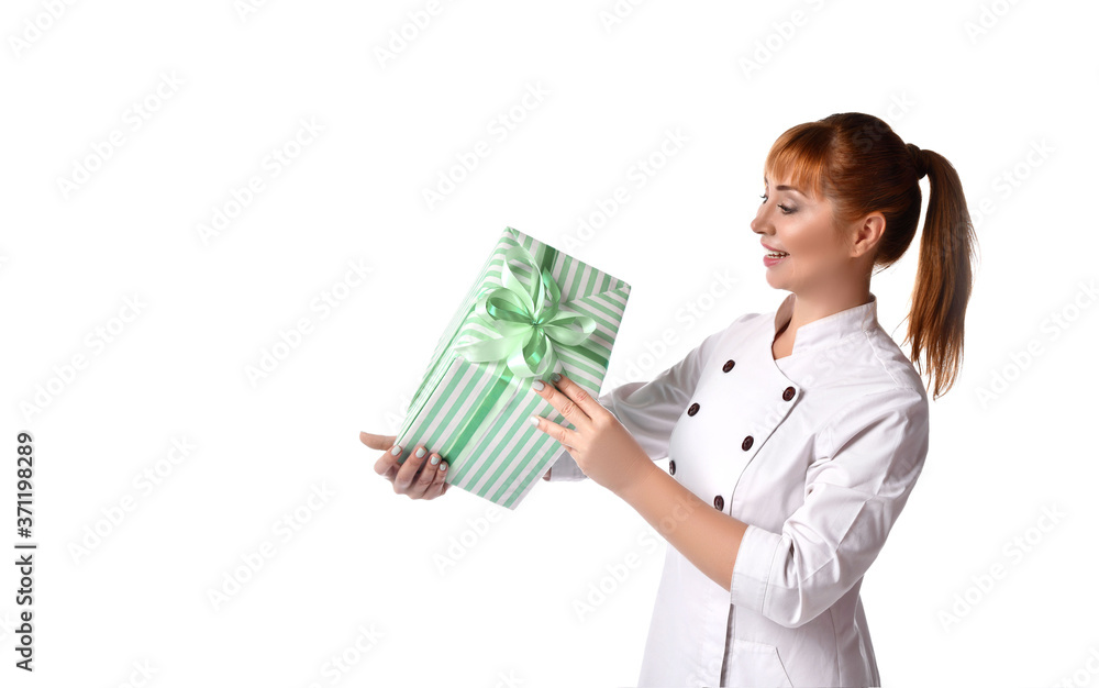 Lady in medical uniform smiling, holding green gift box tied with ribbon. Posing isolated on white. Sales, advertising. Close up Lady in medical uniform smiling, holding green gift box tied with ribbon. Posing isolated on white. Sales, advertising. Close up