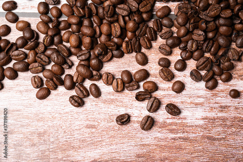 sprinkled coffee beans in a table wood