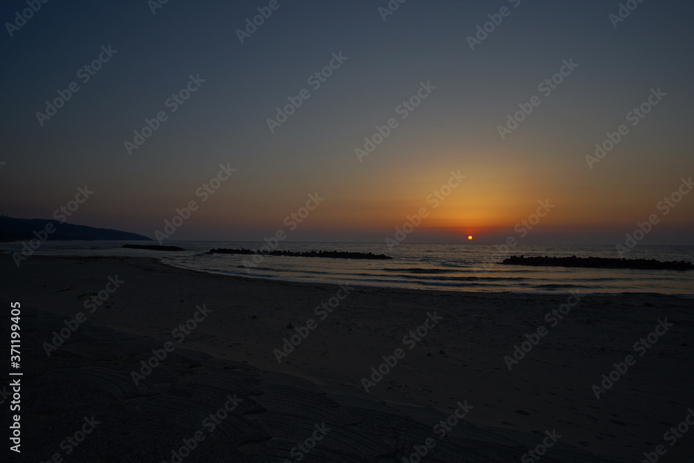 Beautiful orange sunset on the beach, Japan Beautiful orange sunset on the beach, Japan