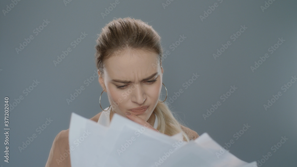 Fototapeta premium Annoyed woman throwing papers in slow motion. Upset professional throw papers