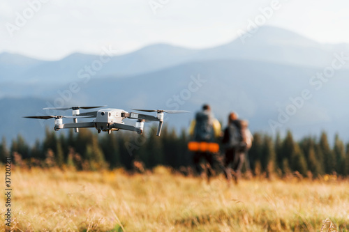 Drone flying near young travelers. Majestic Carpathian Mountains. Beautiful landscape of untouched nature