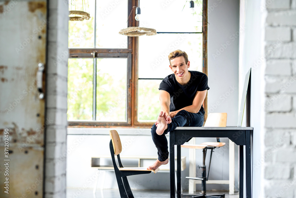 A young handsome Dancer relaxing in a loft style apartment A young handsome Dancer relaxing in a loft style apartment