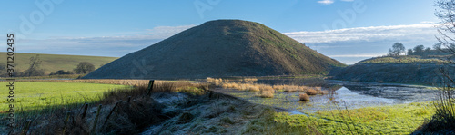 Silbury hill in Wiltshire England. Wintery image with frost on the ground.