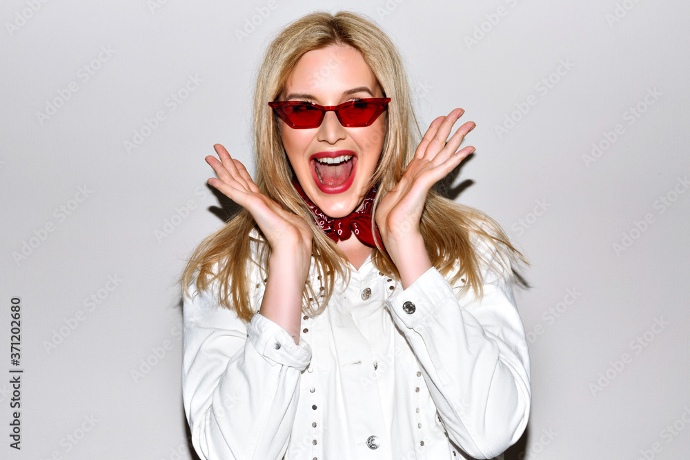 Happy exited woman showing thumbs up and smiling, wearing white hipster jacket and red sunglasses, flash light close up portrait. Happy exited woman showing thumbs up and smiling, wearing white hipster jacket and red sunglasses, flash light close up portrait.