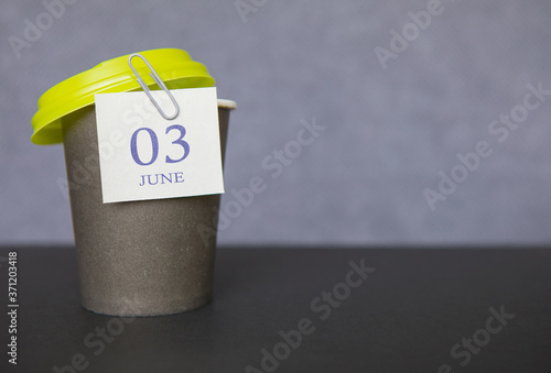 Coffee paper cup with calendar dates for June 03, Summer season. Time for relaxing breaks and vacations.