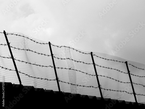 silhouette barbed wire enclose the prison