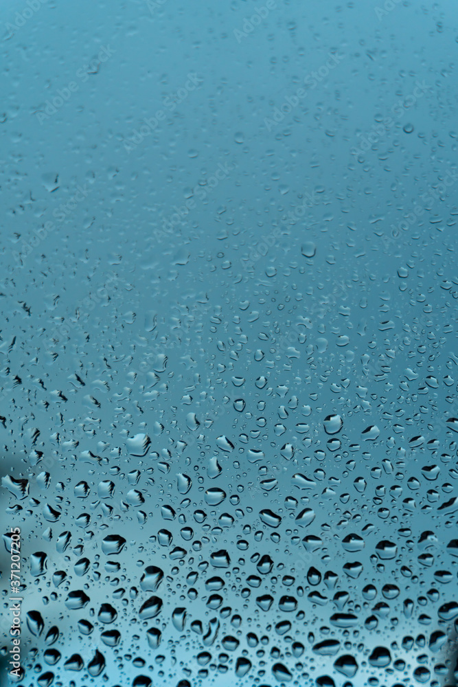 Macro raindrops vapor on window glass. Rain drops on window glasses surface. Through the window view. Drops of rain on glass. Water pattern texture Macro raindrops vapor on window glass. Rain drops on window glasses surface. Through the window view. Drops of rain on glass. Water pattern texture