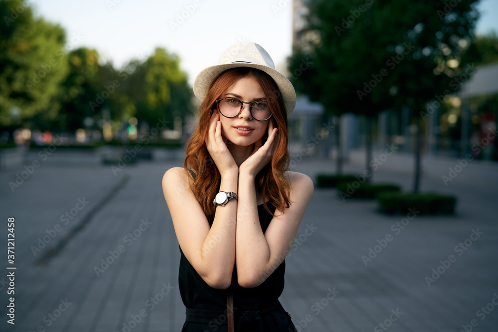 fashionable woman on city street in black dress and hat glasses makeup model watch on hand fresh air fashionable woman on city street in black dress and hat glasses makeup model watch on hand fresh air