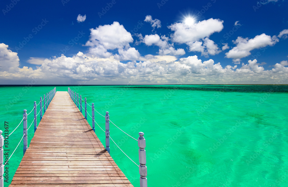 Fototapeta premium wooden bridge juts out into of the sea
