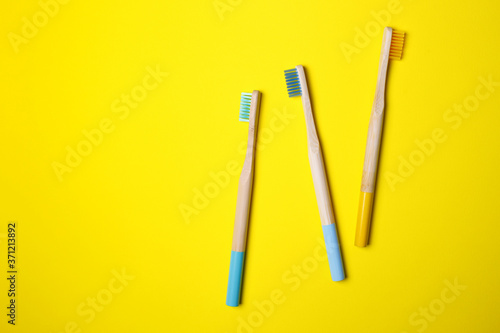 bright toothbrushes on a yellow background