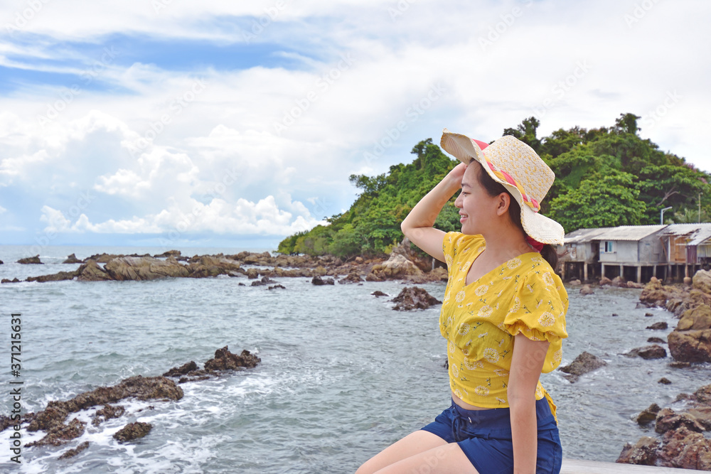 Traveler Asian woman on vacation at the coast of the sea Thailand
