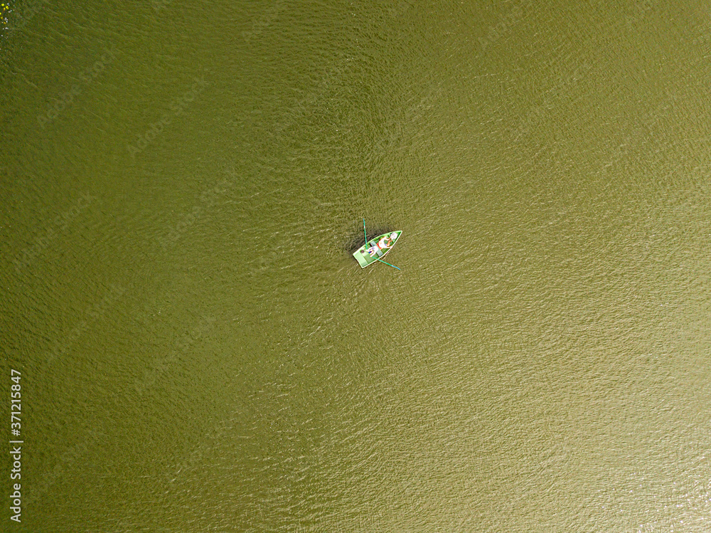 Aerial drone view. Fishing boat on the river on a summer day. Aerial drone view. Fishing boat on the river on a summer day.