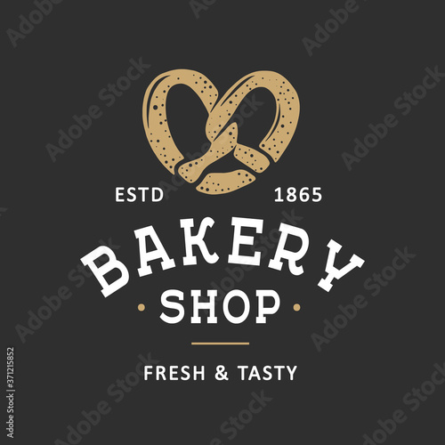 Vintage style bakery shop simple label, badge, emblem, logo template. Graphic food art with engraved pretzel design vector element with typography. Linear organic bagel on black background.